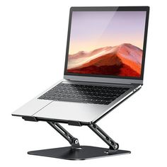 an open laptop computer sitting on top of a metal stand