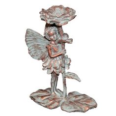 a statue of a fairy holding a flower