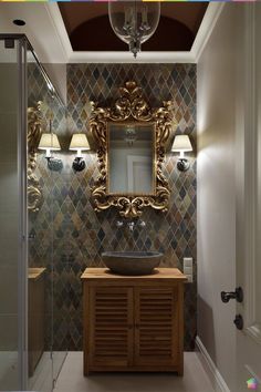 a bathroom with a sink, mirror and lights