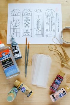 craft supplies laid out on a table including glue, paint, scissors and other items