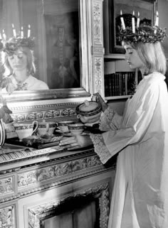 a woman wearing a crown standing in front of a mirror