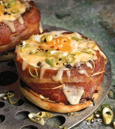 two breads with cheese and other toppings on top of them sitting on a plate