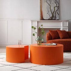 an orange coffee table sitting on top of a white rug in front of a couch