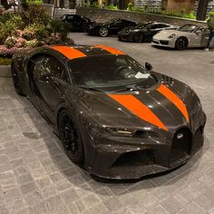 a black and orange sports car parked in a parking lot