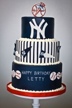 a three tiered birthday cake decorated with baseballs