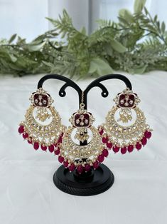 Kundan jewelry set includes a pair of earrings and a tikka. Colour: red Red Chandelier Earrings For Festive Parties, Red Chandelier Earrings For Party And Festive Occasions, Festive Red Chandelier Earrings For Party, Bollywood Ruby Jewelry With Matching Earrings, Traditional Ruby Bridal Earrings For Party, Red Bollywood Dangle Jewelry, Bollywood Style Red Dangle Jewelry, Red Bridal Earrings For Party, Red Bridal Earrings For Festive Party