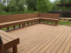 a wooden bench sitting on top of a wooden deck