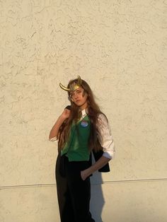 a young woman dressed in costume poses for the camera with her hand on her hip