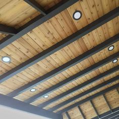 the ceiling is covered with wooden planks and lights