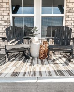 two chairs and a table on the front porch