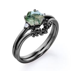 Nature Three Stone Ring 0.55 carat Hexagon Moss Agate and Moissanite Bridal Ring Set in Black Gold contains one 3 stone engagement ring and nature contoured wedding band. The promise ring boasts a 0.5 carat hexagon moss green agate with 2 round Moissanite stones. The sleek band is well polished and it syncs with weddin Green Wedding Rings, Contoured Wedding Band, Green Engagement Rings, 3 Stone Engagement Ring, Hexagonal Ring, Promise Rings For Guys, Cute Engagement Rings, Black Engagement Ring, Future Engagement Rings