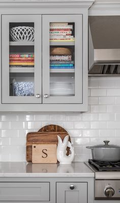 a wooden cutting board sitting on top of a kitchen counter