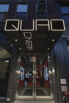 the entrance to an office building with neon lights