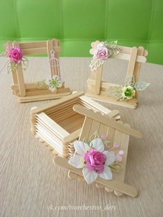 three small wooden frames with flowers on them