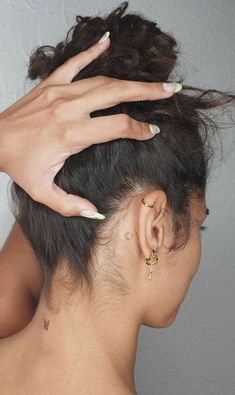 a woman's hand on top of her head while she is getting her hair done