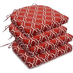 four red and white pillows stacked on top of each other