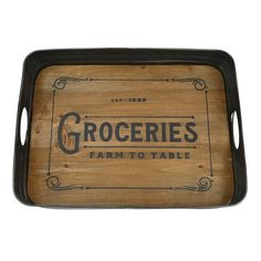 a wooden tray with the words groceries farm to table written on it and an ornate border