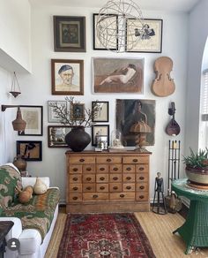 a living room filled with furniture and pictures on the wall