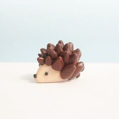 a small hedgehog toy sitting on top of a white table next to a blue wall