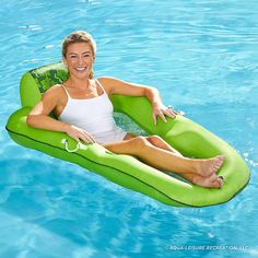 a woman is sitting on an inflatable floating pool floatie and smiling at the camera