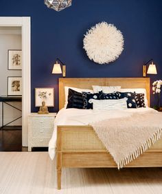 a bedroom with blue walls and white furniture