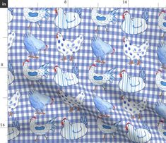 a blue and white checkered fabric with chickens on it