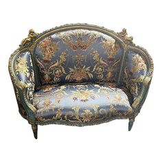 an ornately decorated couch with blue and gold paint on it's upholstered back