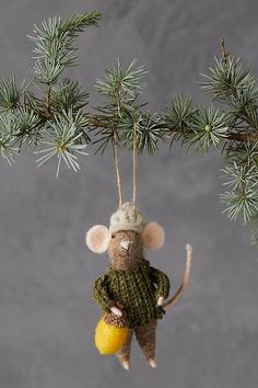 a mouse ornament hanging from a pine tree