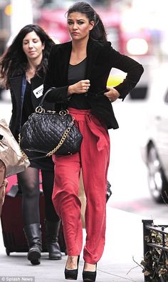 two women are walking down the street with their handbags and purses in tow