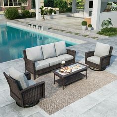 an outdoor patio furniture set near a swimming pool