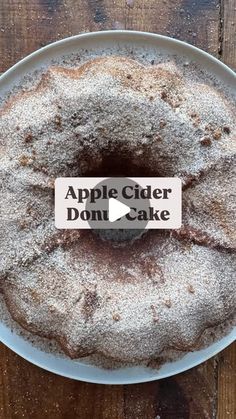 an apple cider donut cake on a plate with a sign that reads, apple cider donut cake