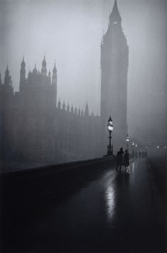 the big ben clock tower towering over the city of london in foggy weather,