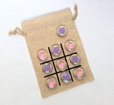 a tic - tac - toe bag with pink and purple hearts on it