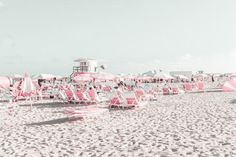 there are many chairs and umbrellas on the beach