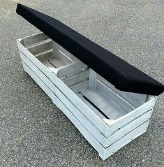 an empty white box with a black surfboard in it