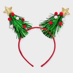 a red headband with green and gold decorations on it's ears is shown