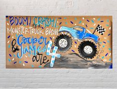 a painted sign on the side of a white brick wall that says boom crash monster truck bash