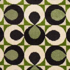 a green and black rug with circles on it