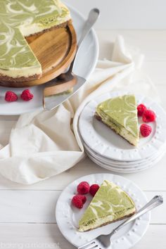 a slice of cheesecake with raspberries on plates