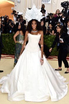 an image of a woman in a wedding dress at the red carpet event with cameras around her