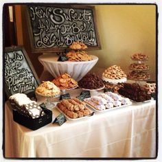 a table topped with lots of different types of cookies and pastries on top of it