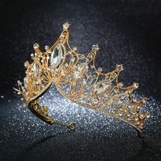 a gold tiara with crystal stones on it