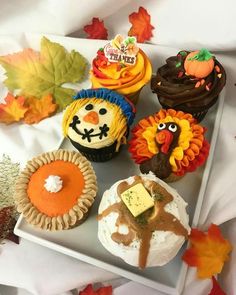 cupcakes decorated with thanksgiving decorations on a tray