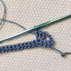 the crochet hook is being worked on by someone who has knitted it