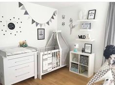 a baby's room is decorated in white and black