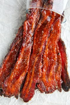 bacon strips in a plastic container sitting on wax paper