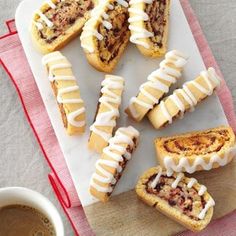 several pastries on a plate next to a cup of coffee