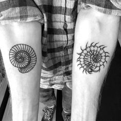 two people with tattoos on their legs and one has a spiral design on the arm