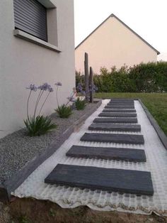 an outdoor walkway made out of stones and gravel