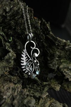 ITEM DESCRIPTION: The size H 4 cm x W 2 cm (1 2/3 x 3/4 inch). Weight - 4 g. You can buy it with a silver chain or without it. I made this pretty plant necklace of sterling silver, labradorite, and garnet. It looks like a part of magic woodland, where ferns, mushrooms, and fairies hide. This jewelry is made of very high quality. And it is filled with a genuine love for nature. I am sure it will bring you many pleasant memories and compliments. Ooak jewelry made by eco-friendly materials. This ha Mushrooms And Fairies, Fern Jewelry, Goblin Aesthetic, Laser Patterns, Cottage Core Jewelry, Plant Necklace, Pretty Plant, Necklace Pendent, Forest Jewelry